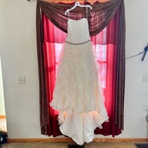 Ivory color wedding gown size 14 never worn w/tags.